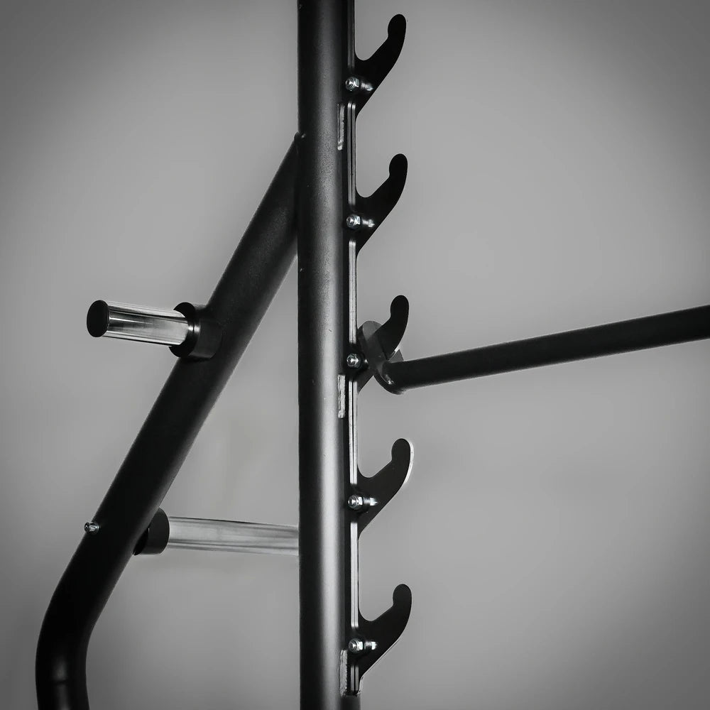 Black metal barbell rack with hooks on a gray background