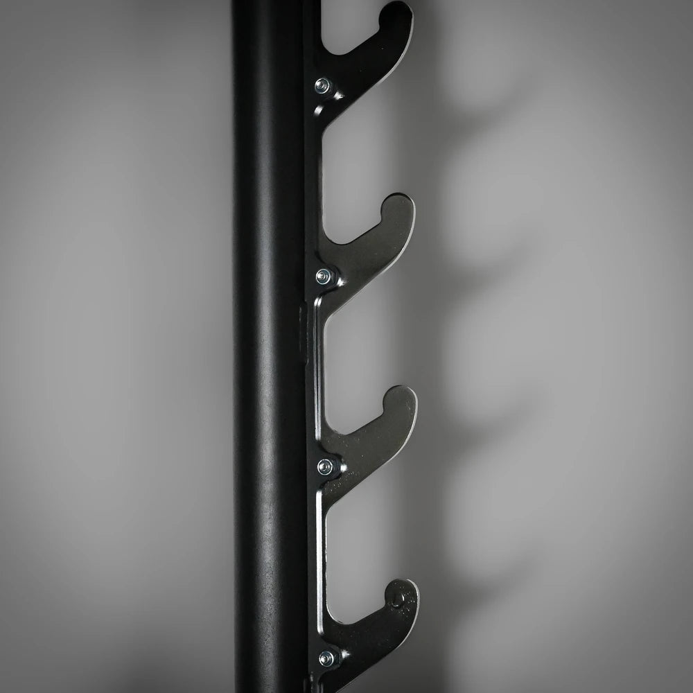 Black metal wall-mounted rack on a gray background