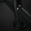 Close-up of a black metal bar with a bolt on a dark background