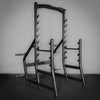 Gym power rack against a plain wall