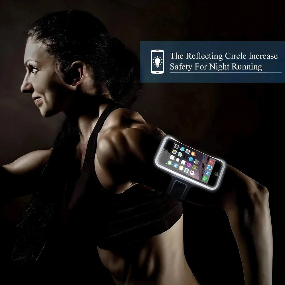 Person wearing a phone armband with a reflective circle, set against a dark background.