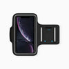 Black phone armband with smartphone displaying a reflective screen on a white background