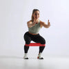 Woman exercising with a resistance band on a white background