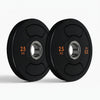 Two black weight plates on a white background