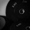 Close-up of gym bumper plates on a dark background