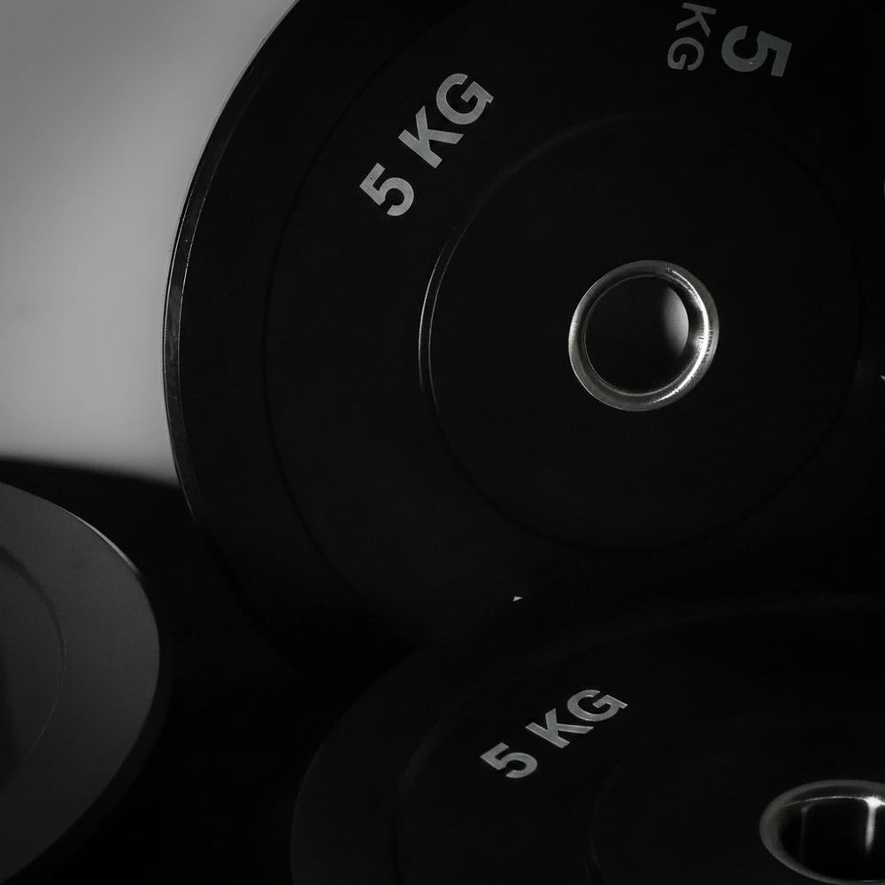Close-up of gym bumper plates on a dark background