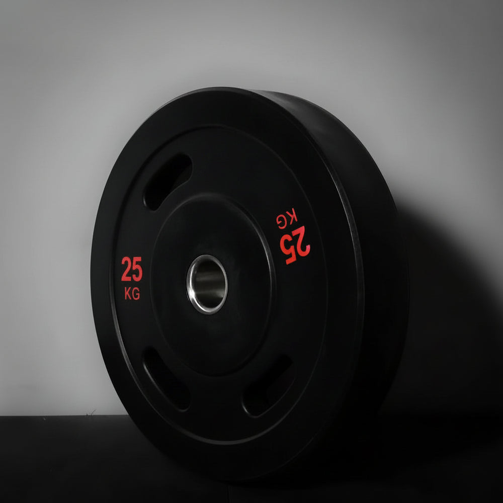Black gym weight plate with red text on a gray background