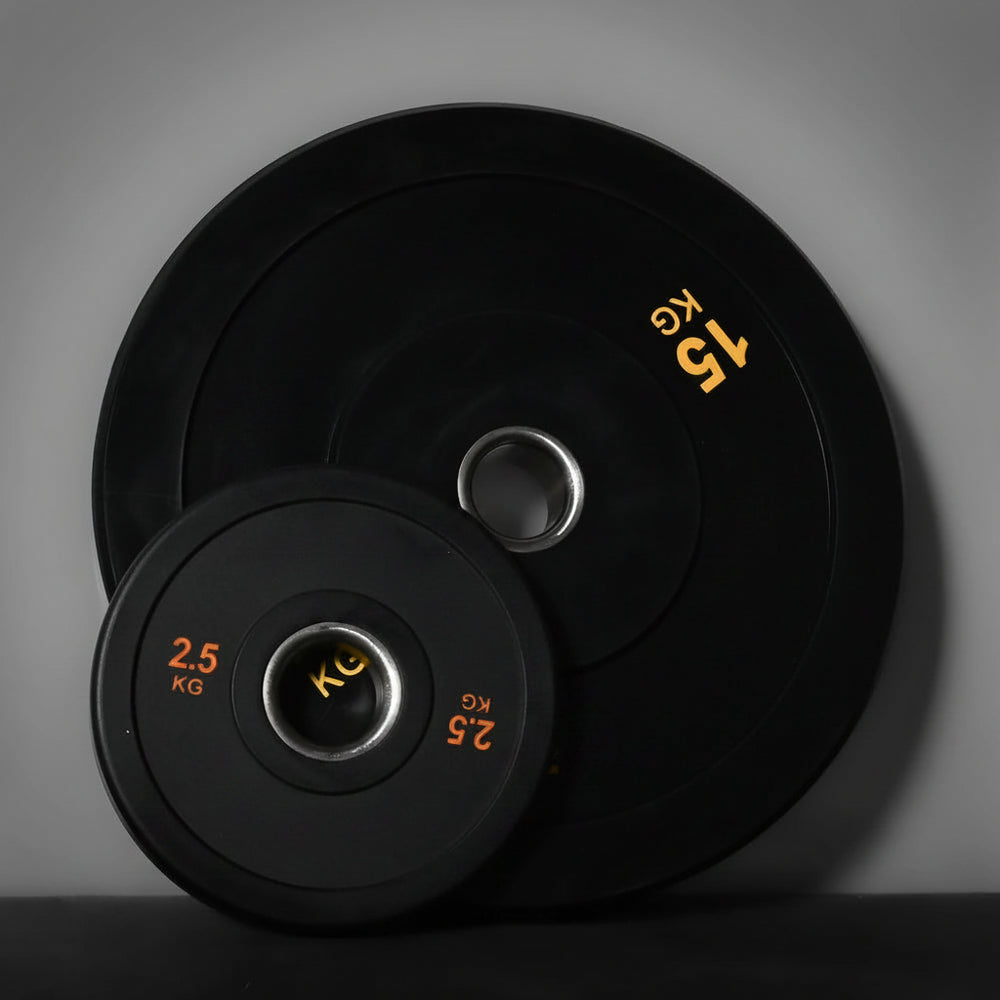 Two black weight plates on a gray background