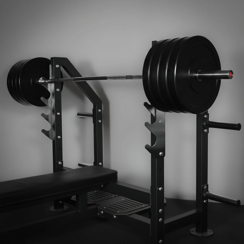 Barbell with weights on a squat rack in a gym setting