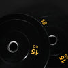 Two black weight plates with yellow text on a black background