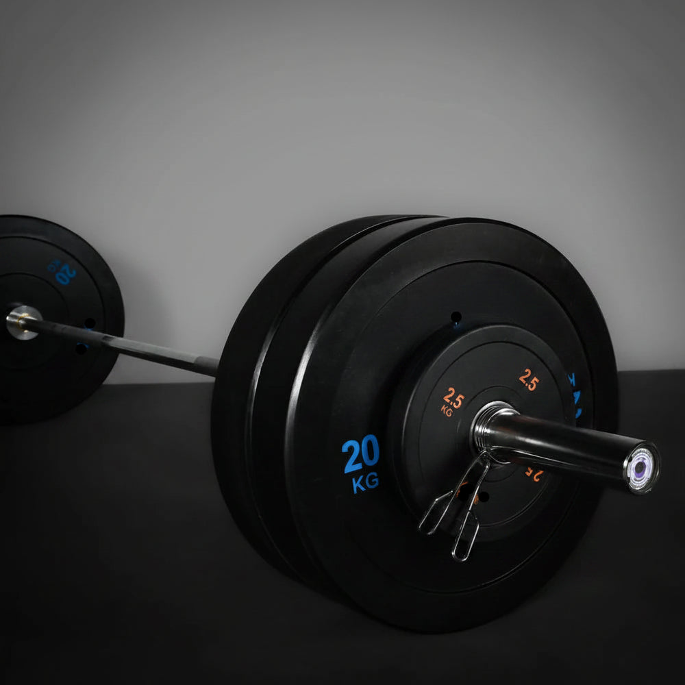 Weightlifting barbell with black weight plates on a dark background