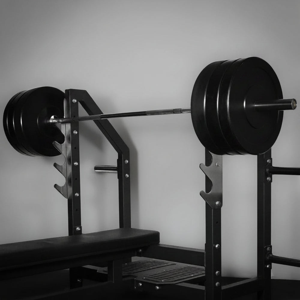 Weightlifting barbell with weights on a rack against a gray wall