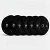 Set of black gym weight plates with weight markings on a white background