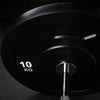 Black weight plate on a dark background