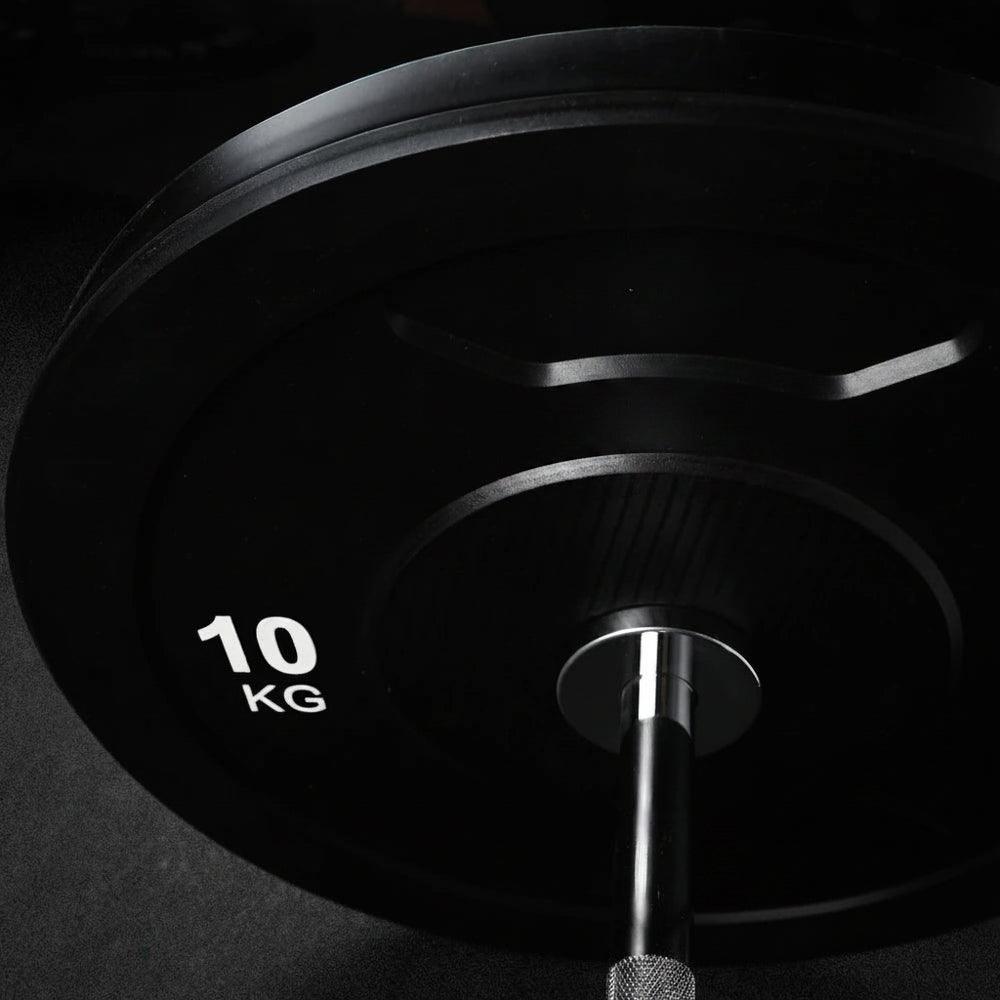 Black weight plate on a dark background