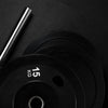 Black weight plates on a dark background