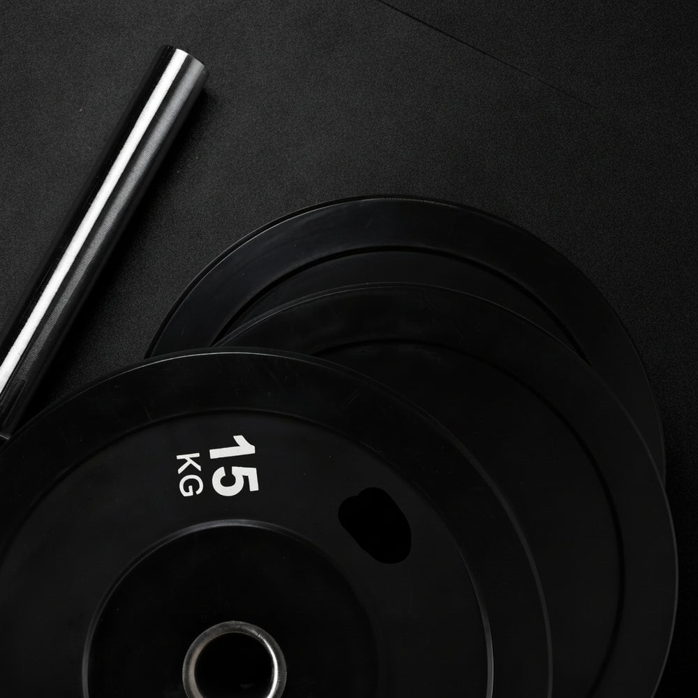 Black weight plates on a dark background
