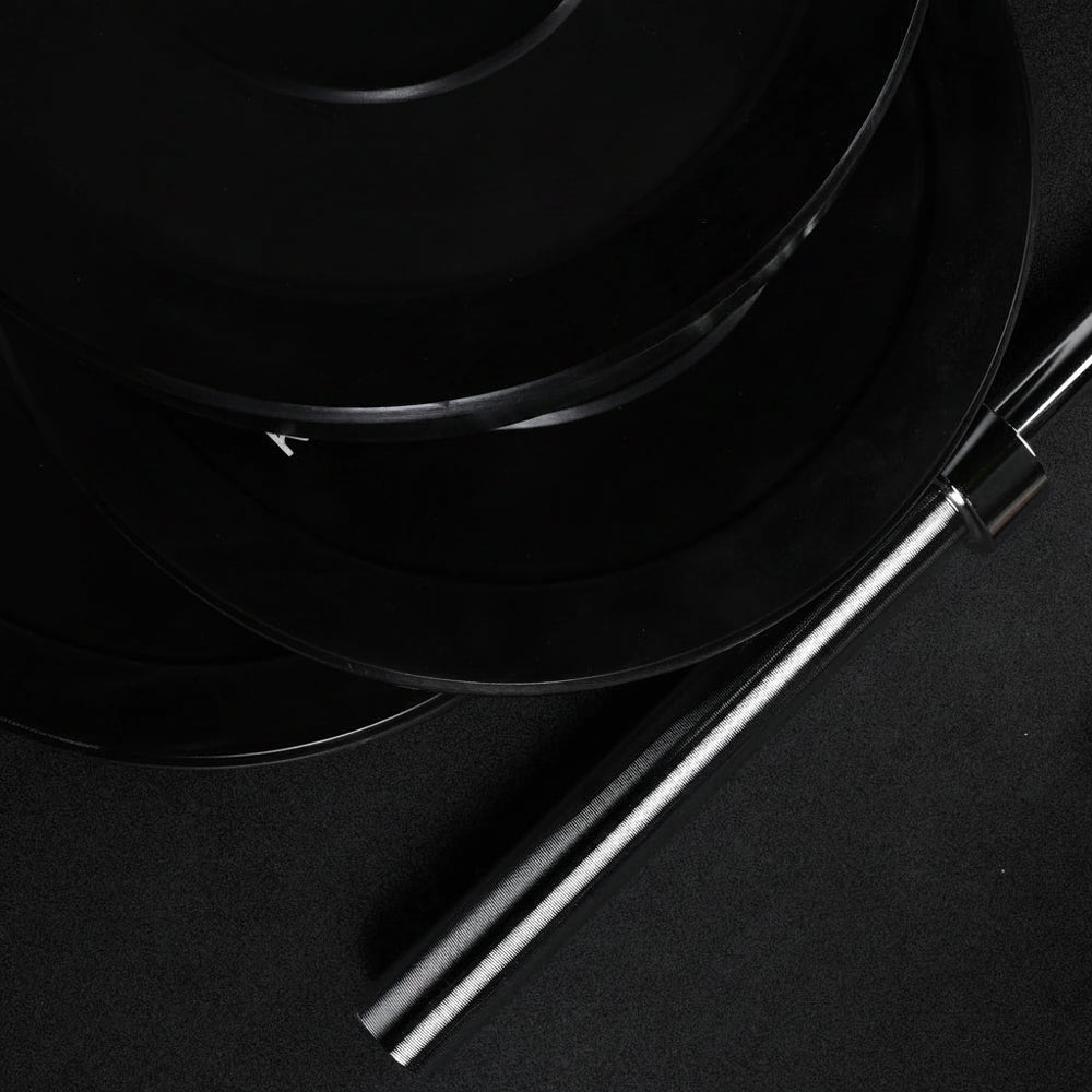 Stack of gym weight plates on a black background