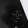 Black weight plates with white text on a black background