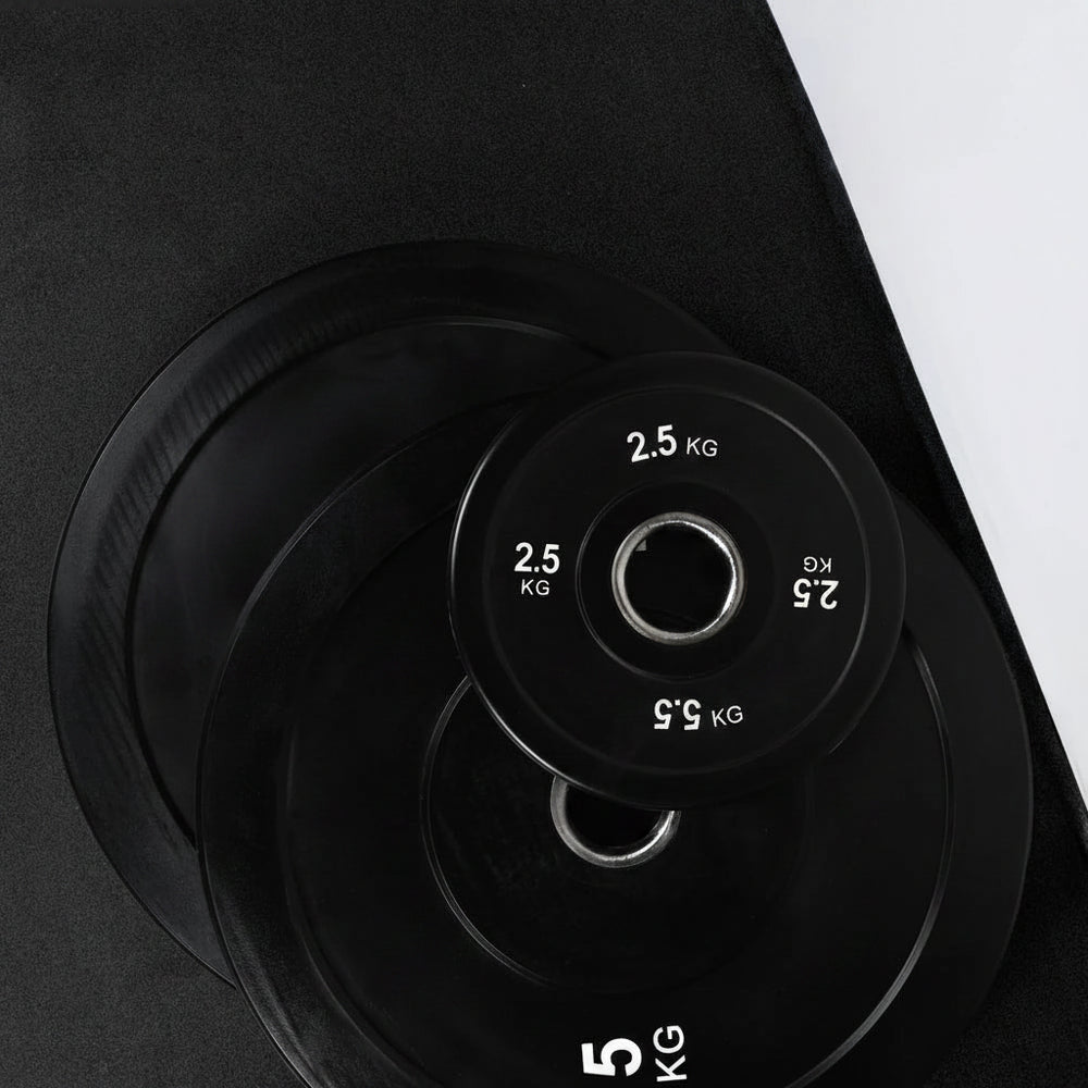 Black weight plates with white text on a black background