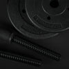Two black weight plates with measurement markings on a dark background