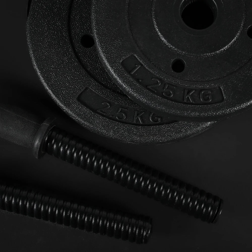 Two black weight plates with measurement markings on a dark background