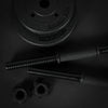 Pair of black dumbbells with weight plates on a dark background