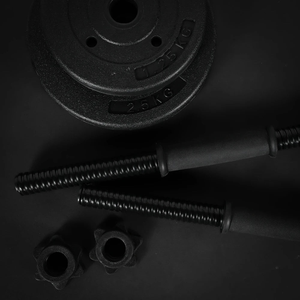 Pair of black dumbbells with weight plates on a dark background