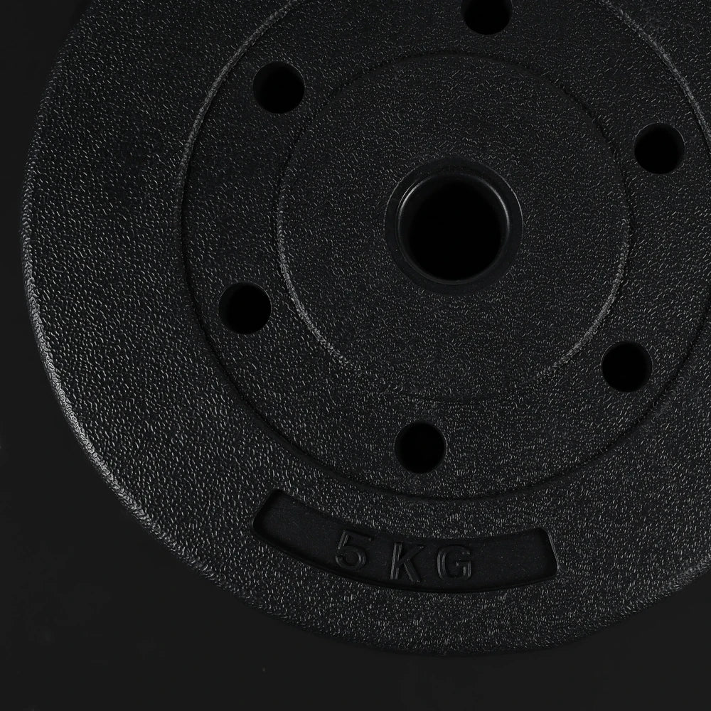 Black weight plate with '5 KG' marking on a black background