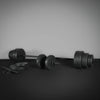 Barbell with weights on a dark surface against a gray background