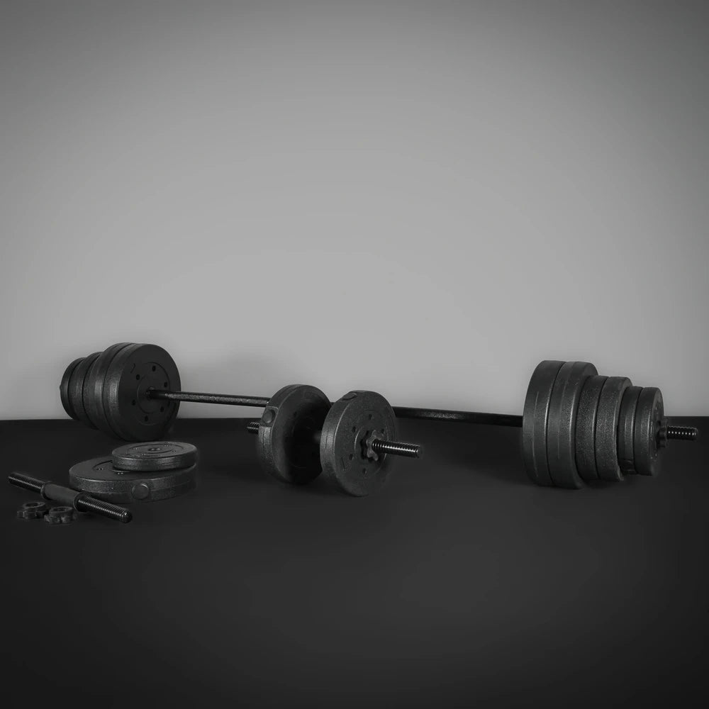 Barbell with weights on a dark surface against a gray background