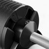 Close-up of a black and silver exercise roller with textured surface