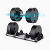 Black adjustable dumbbell set with a stand on a white background