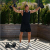 Man exercising with dumbbells outdoors on a wooden deck