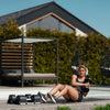 Woman exercising with dumbbells outdoors on a patio