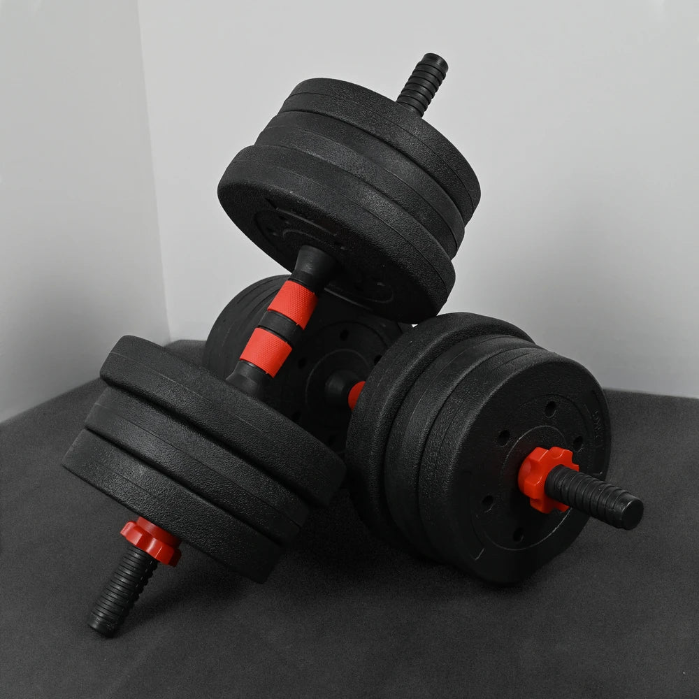 Pair of black dumbbells with red accents on a dark surface