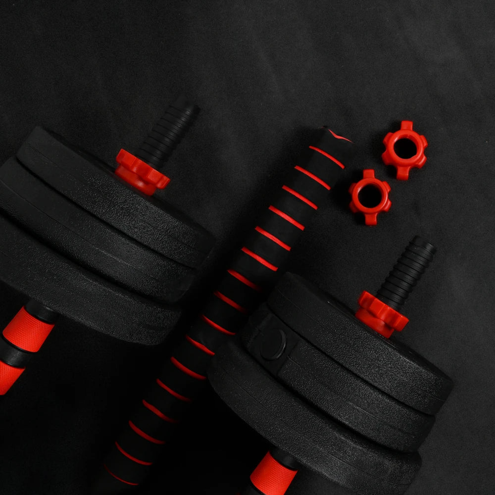 Pair of black dumbbells with red attachments on a dark background