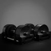 Set of black dumbbells on a dark background