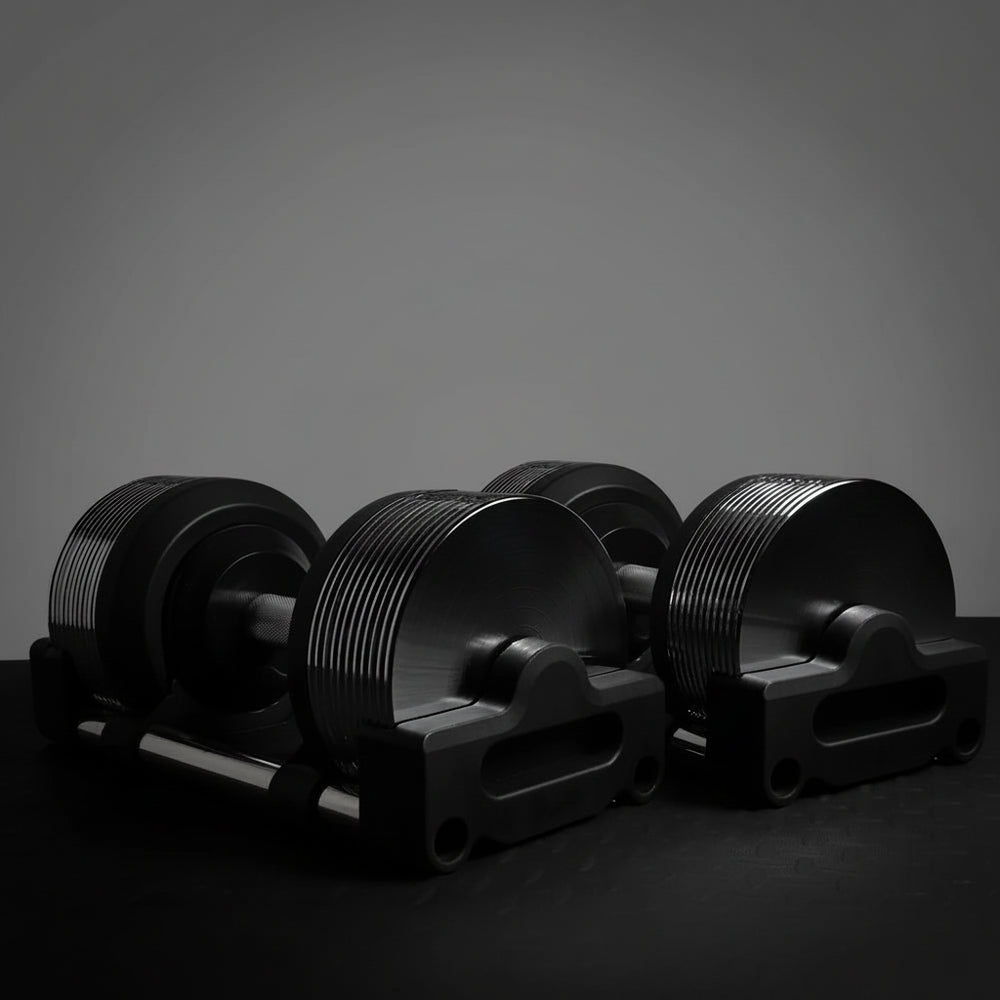 Set of black dumbbells on a dark background