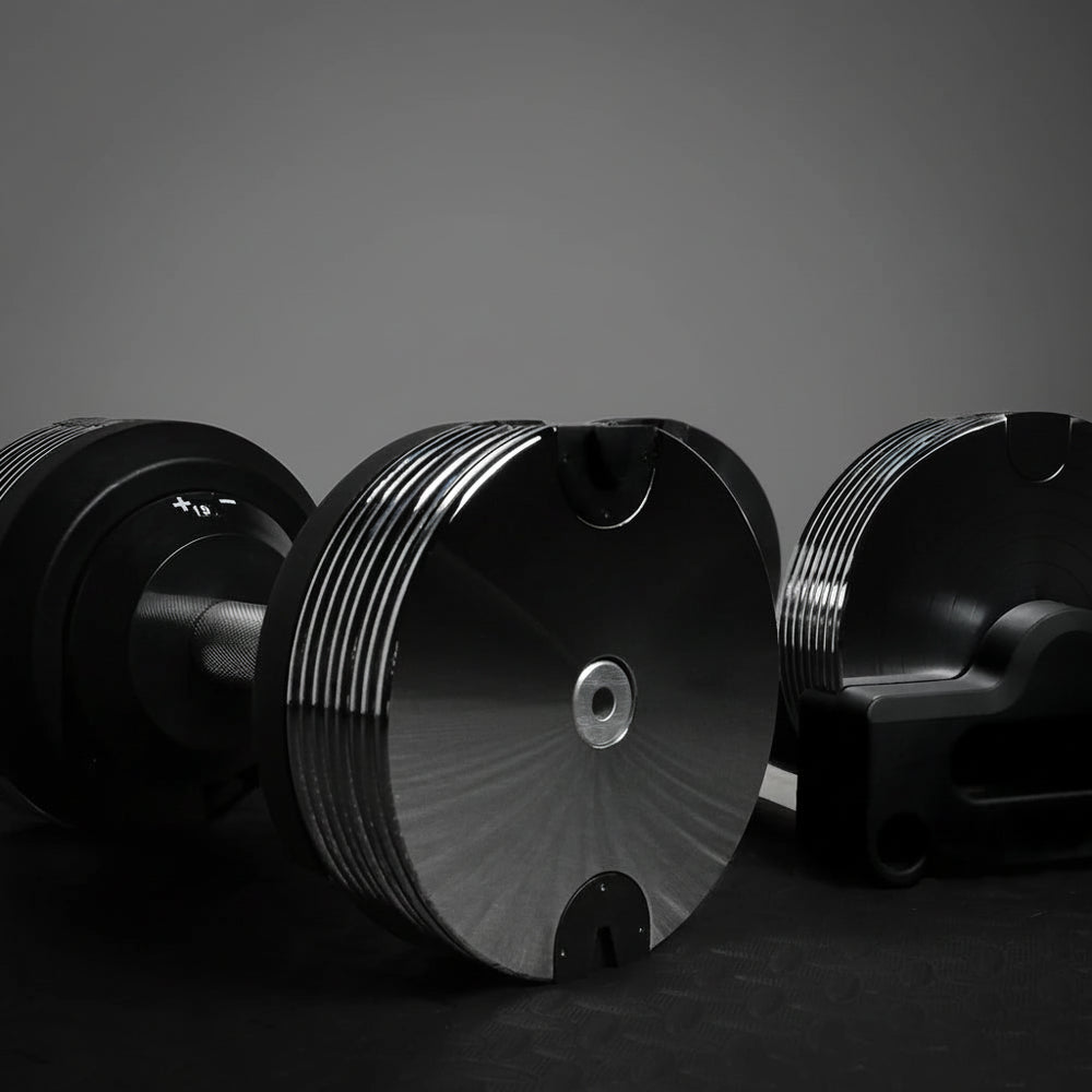 Three metallic objects with a reflective surface on a dark background