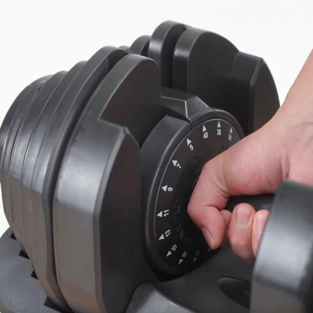 Hand adjusting a black adjustable dumbbell on a white background