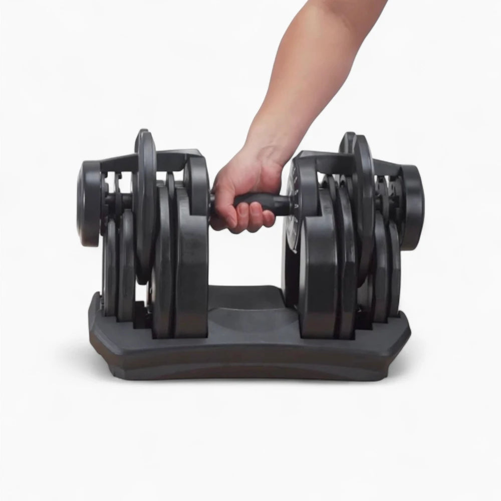 Person holding a pair of adjustable dumbbells on a white background