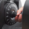 Hand turning a dial on an old-fashioned telephone