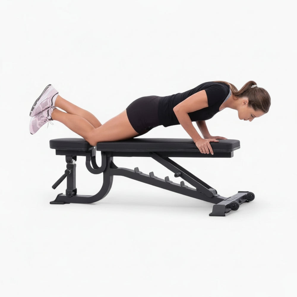 Woman exercising on a black adjustable weight bench against a white background
