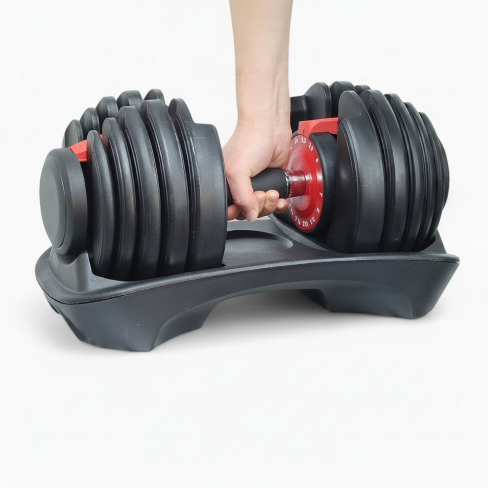 Adjustable dumbbell set with a hand holding one of the weights on a white background