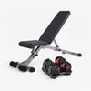 Black adjustable weight bench with red accents and a pair of dumbbells on a white background