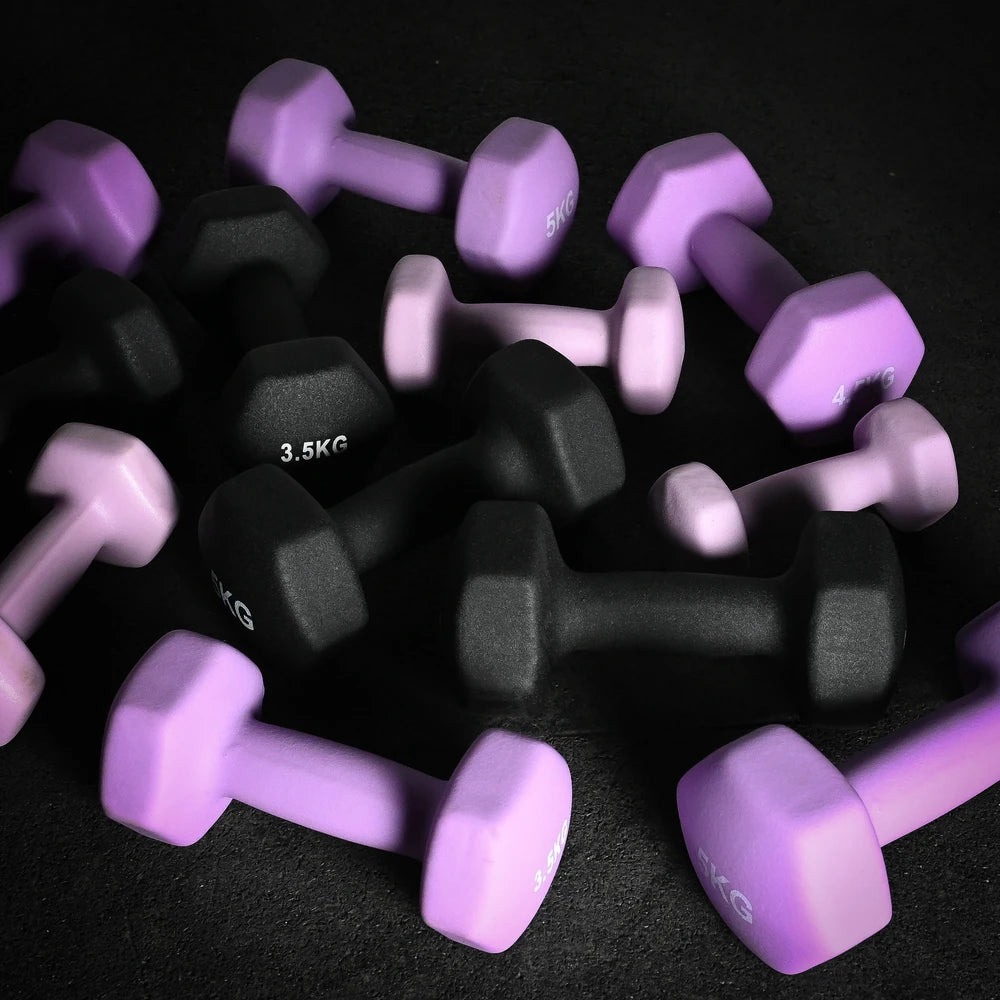 Purple and black dumbbells scattered on a dark surface
