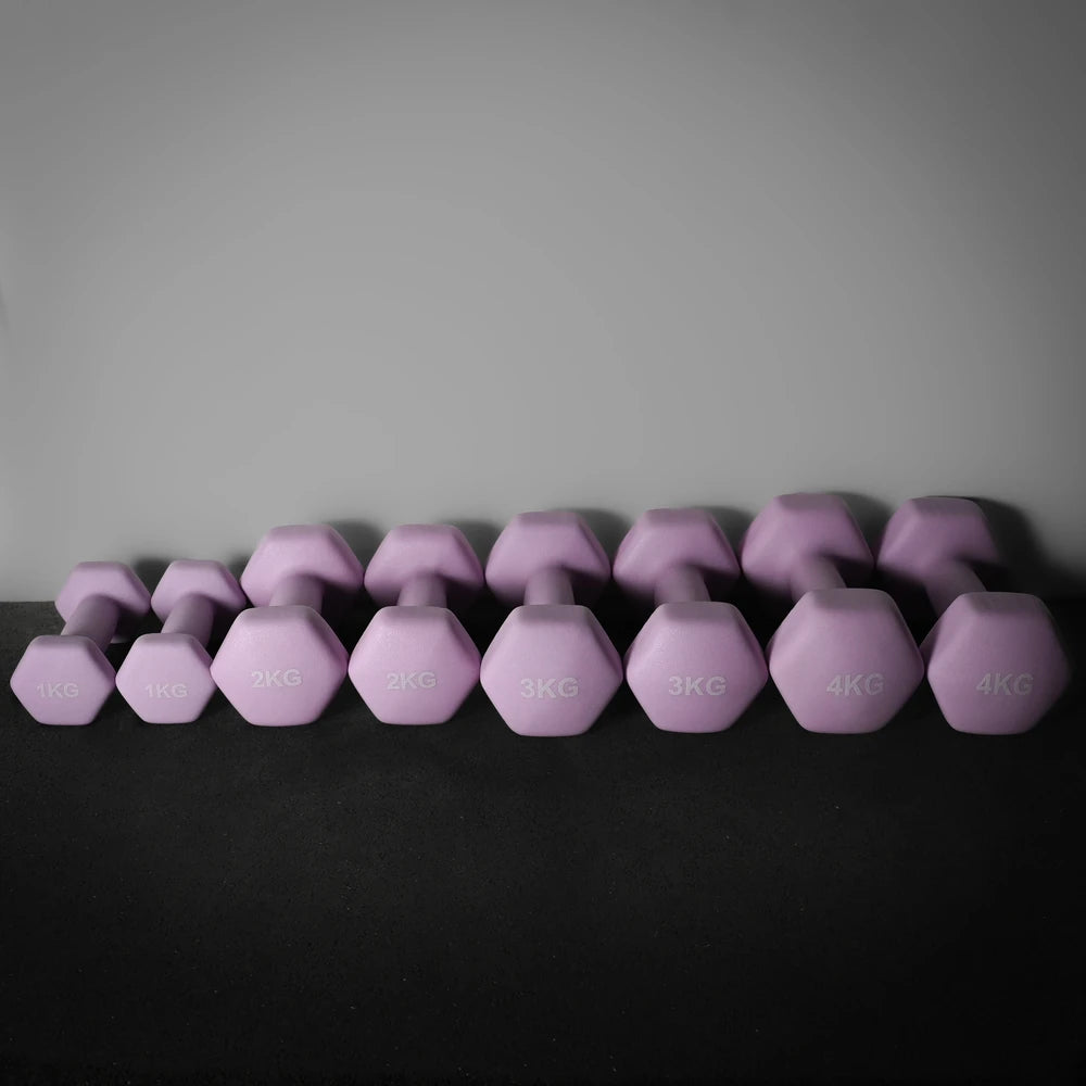Row of purple dumbbells with weight markings on a dark surface and gray background