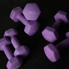 Purple dumbbells with weight markings on a black background