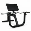 Black gym machine on a dark floor with a white wall background